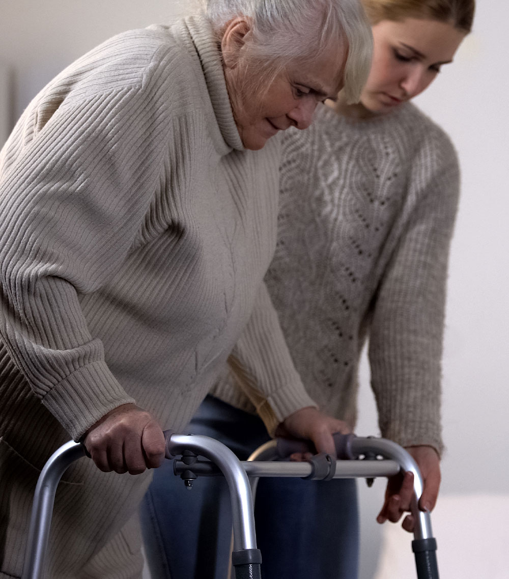 An elderly woman with a walker
