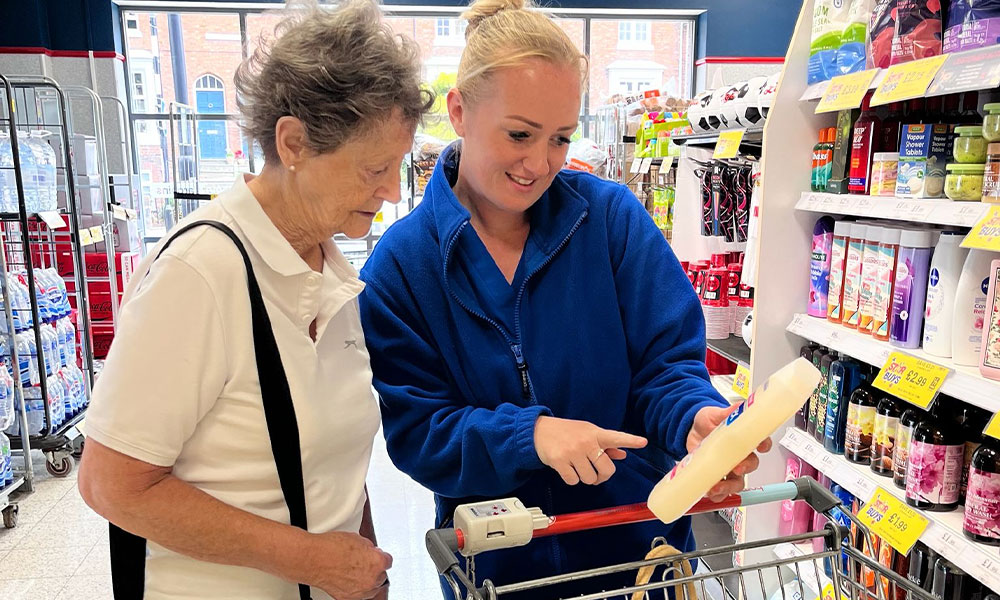 Two women choosing groceries together in a supermarket